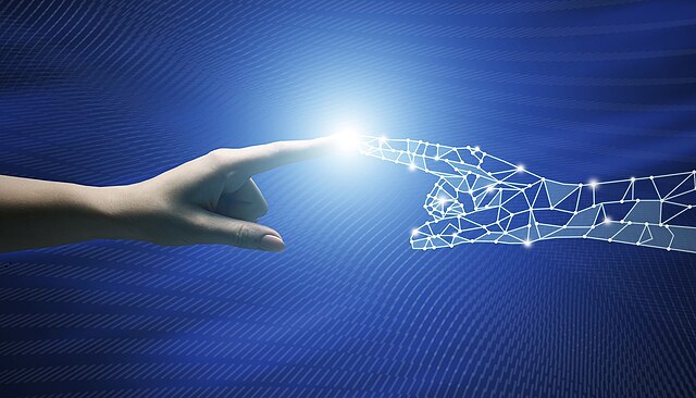 A human hand and a digital hand made of lines reach out to touch fingertips against a blue background.